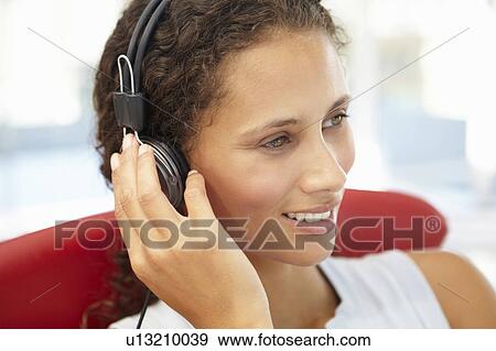 Stock Photo - Young woman with headphones. Fotosearch