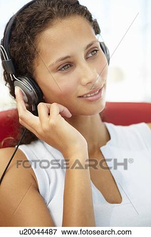 Stock Photo - Young woman with headphones. Fotosearch