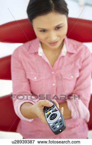 Young woman with remote control View Large Photo Image Stock Photo - Young woman with remote control. Fotosearch