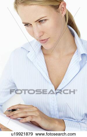 Stock Photo - Young woman writing reading. Fotosearch
