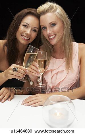 Stock Image - Young women in restaurant. Fotosearch