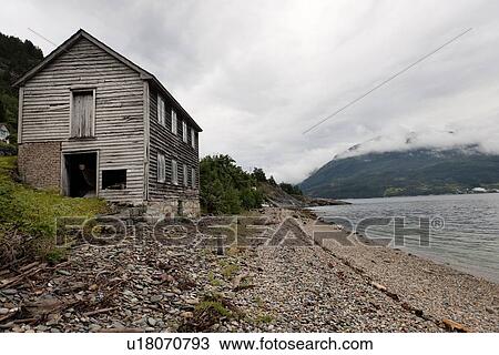 Stock Image - Abandoned wooden house at the coast, Hardanger, Hardangerfjord, Hardangervidda, Hardanger, Norway. Fotosearch