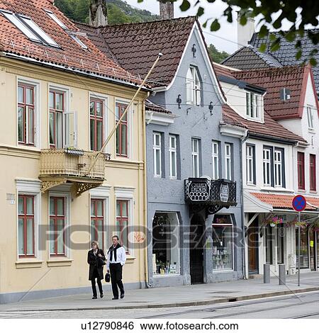 Couple walking on a sidewalk, Bergen, Norway View Large Photo Image Stock Photograph - Couple walking on a sidewalk, Bergen, Norway. Fotosearch