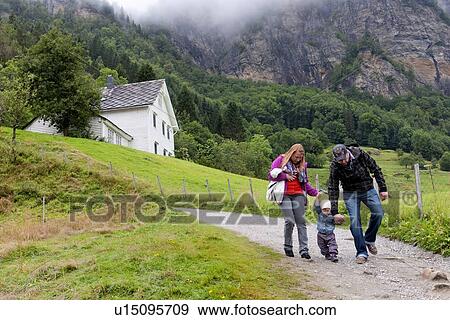 Couple walking with their baby, Steinsdalsfossen, Hardangervidda, Hardanger, Norway View Large Photo Image Stock Photo - Couple walking with their baby, Steinsdalsfossen, Hardangervidda, Hardanger, Norway. Fotosearch