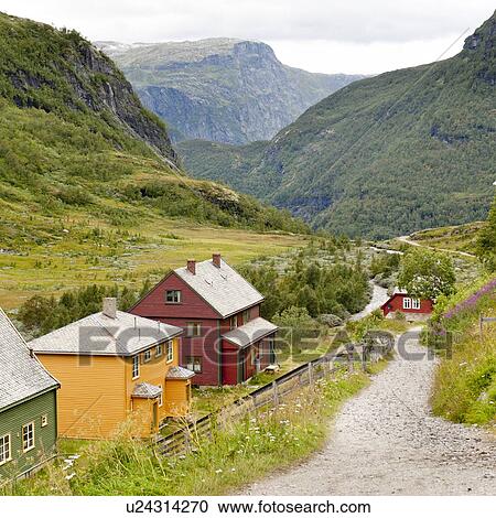 Stock Image - Dirt road passing through mountains, Norway. Fotosearch