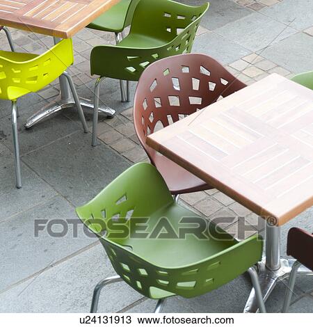 Stock Image - Empty chairs and tables at a sidewalk cafe, Bergen, Norway. Fotosearch