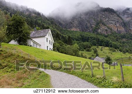 Stock Image - Fog over mountains, Steinsdalsfossen, Hardangervidda, Hardanger, Norway. Fotosearch