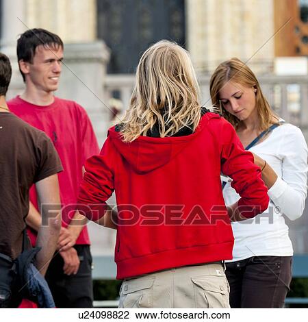Stock Image - Friends standing on the street, Oslo, Norway. Fotosearch