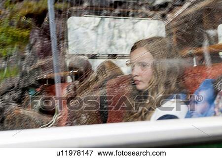 Girl sitting at a window on a tour bus, Norway View Large Photo Image Stock Photo - Girl sitting at a window on a tour bus, Norway. Fotosearch