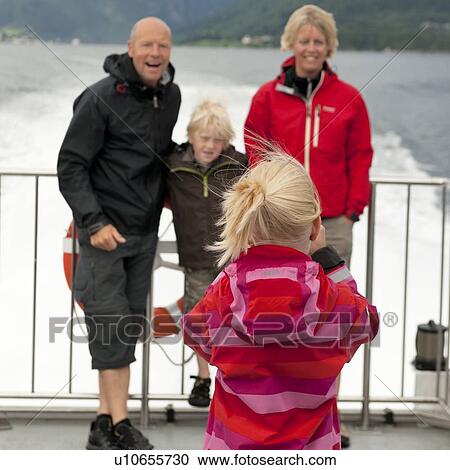 Girl taking picture of her family, Sognefjord, Norway View Large Photo Image Stock Image - Girl taking picture of her family, Sognefjord, Norway. Fotosearch