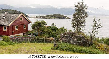 Stock Photo - House at waterfront, Hardanger, Hardangerfjord, Hardangervidda, Hardanger, Norway. Fotosearch