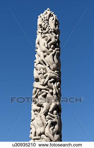 Stock Image - Low angle view of a carved column, The Monolith, Gustav Vigeland Sculpture Park, Frogner Park, Oslo, Norway. Fotosearch