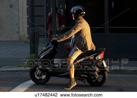 Man riding a motor scooter, Oslo, Norway View Large Photo Image Stock Image - Man riding a motor scooter, Oslo, Norway. Fotosearch