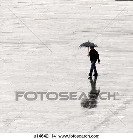 Man walking on the road during rain, Bergen, Norway View Large Photo Image Picture - Man walking on the road during rain, Bergen, Norway. Fotosearch