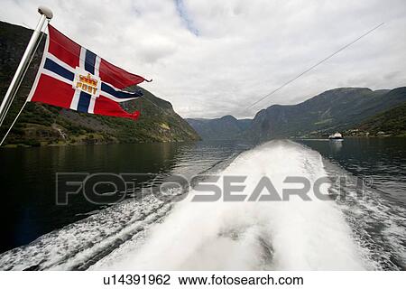 Norwegian flag on a ship in the fjord, Aurlandsfjord, Sognefjord, Norway View Large Photo Image Stock Image - Norwegian flag on a ship in the fjord, Aurlandsfjord, Sognefjord, Norway. Fotosearch