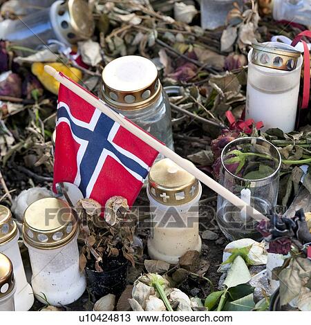 Stock Image - Norwegian flag with candles and flowers at a memorial, Oslo Cathedral, Oslo, Norway. Fotosearch