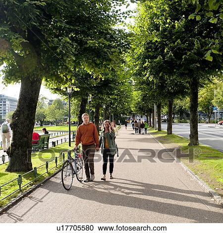 Stock Image - People walking in a park, Norway. Fotosearch