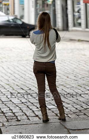 Rear view of a woman standing on a street, Bergen, Norway View Large Photo Image Stock Image - Rear view of a woman standing on a street, Bergen, Norway. Fotosearch