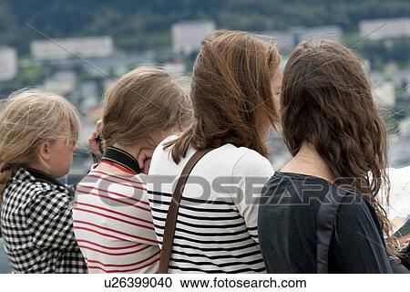 Stock Image - Rear view of four female friends, Floyen, Bergen, Norway. Fotosearch