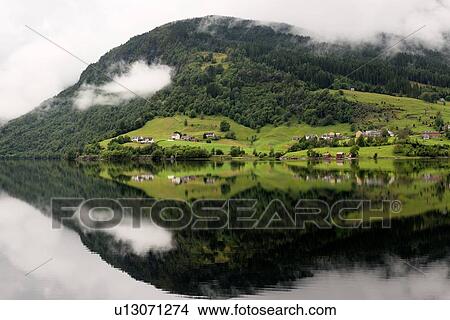 Reflection of mountain with clouds in the lake, Granvinsvatnet, Granvin, Hordaland County, Norway View Large Photo Image Picture - Reflection of mountain with clouds in the lake, Granvinsvatnet, Granvin, Hordaland County, Norway. Fotosearch