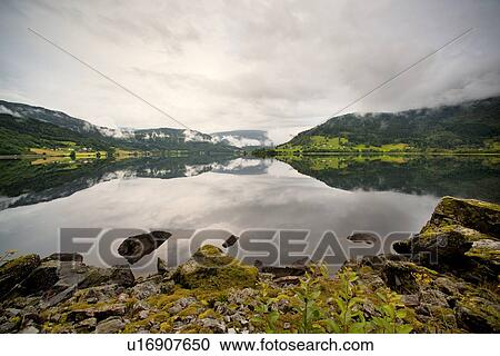Reflection of mountains in the lake, Granvinsvatnet, Granvin, Hordaland County, Norway View Large Photo Image Stock Image - Reflection of mountains in the lake, Granvinsvatnet, Granvin, Hordaland County, Norway. Fotosearch