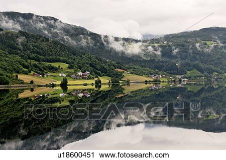 Stock Image - Reflection of mountains in the lake, Granvinsvatnet, Granvin, Hordaland County, Norway. Fotosearch