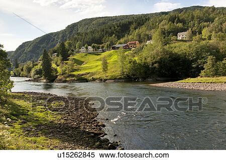River flowing with village in the background, Norway View Large Photo Image Stock Photography - River flowing with village in the background, Norway. Fotosearch