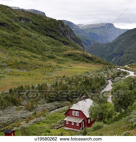 Stock Image - Stream flowing past a farmhouse, Norway. Fotosearch