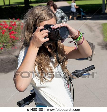 Teenage girl taking a picture with a camera in Gustav Vigeland Sculpture Park, Frogner Park, Oslo, Norway View Large Photo Image Stock Image - Teenage girl taking a picture with a camera in Gustav Vigeland Sculpture Park, Frogner Park, Oslo, Norway. Fotosearch