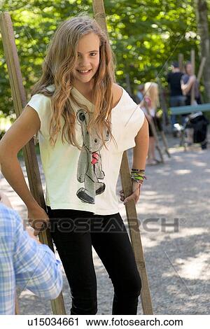 Stock Image - Teenage girl walking with sticks in Norsk Folkemuseum, Oslo, Norway. Fotosearch