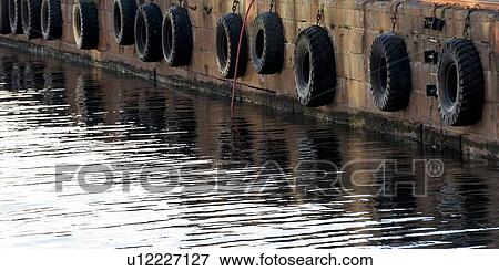 Tires hanging on a jetty, Stranden, Oslo, Norway View Large Photo Image Stock Photo - Tires hanging on a jetty, Stranden, Oslo, Norway. Fotosearch