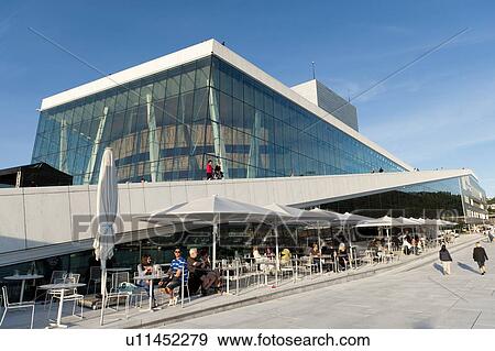 Stock Photo - Tourists at a sidewalk cafe in front of Oslo Opera House, Oslo, Norway. Fotosearch