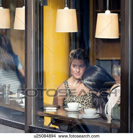 Two women sitting in a restaurant, Oslo, Norway View Large Photo Image Picture - Two women sitting in a restaurant, Oslo, Norway. Fotosearch