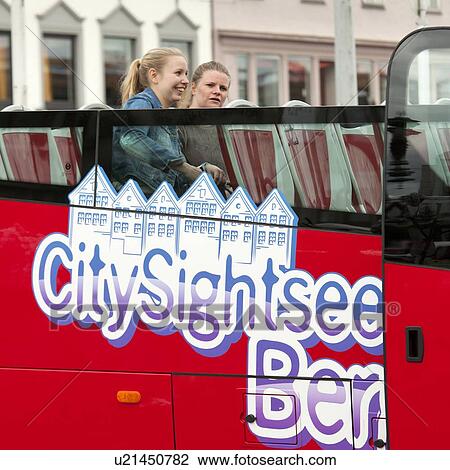 Two women sitting in a tour bus, Bergen, Norway View Large Photo Image Stock Image - Two women sitting in a tour bus, Bergen, Norway. Fotosearch