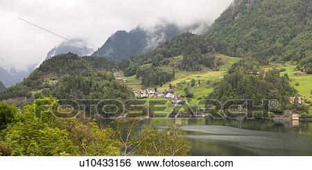 Stock Photograph - Village at waterfront, Hardanger, Hardangerfjord, Hardangervidda, Hardanger, Norway. Fotosearch