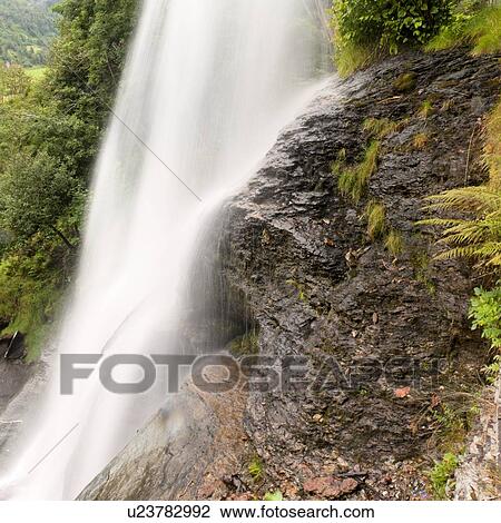 Stock Image - Waterfall in a forest, Steinsdalsfossen, Norheimsund, Hardangervidda, Hardanger, Norway. Fotosearch