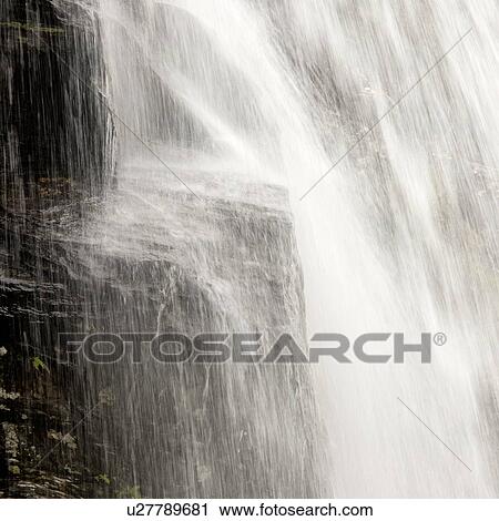 Stock Image - Waterfall in a forest, Steinsdalsfossen, Norheimsund, Hardangervidda, Hardanger, Norway. Fotosearch