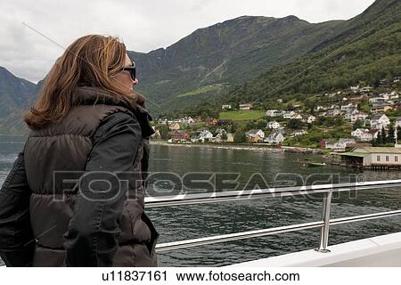 Woman looking at a view from a boat, Norway View Large Photo Image Stock Image - Woman looking at a view from a boat, Norway. Fotosearch