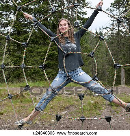 Woman on rope spider web in a park, Bergen, Norway View Large Photo Image Stock Image - Woman on rope spider web in a park, Bergen, Norway. Fotosearch