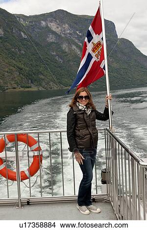 Woman standing on cruise ship deck, Norway View Large Photo Image Picture - Woman standing on cruise ship deck, Norway. Fotosearch