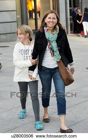 Woman walking with her daughter and smiling, Oslo, Norway View Large Photo Image Stock Photograph - Woman walking with her daughter and smiling, Oslo, Norway. Fotosearch