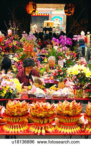 People buying religious offerings at market stall View Large Photo Image Stock Photograph - People buying religious offerings at market stall. Fotosearch