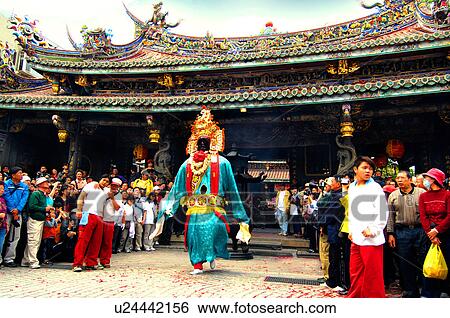 Stock Photograph - People watching performer performing in front of temple. Fotosearch