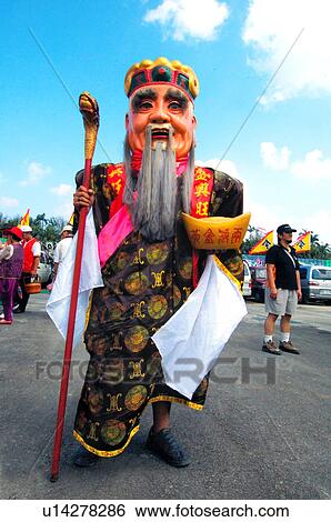 Stock Photograph - Performer in costume standing on a street. Fotosearch