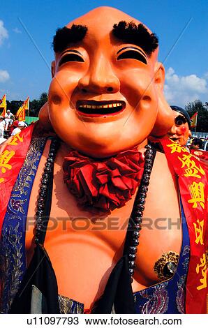 Stock Image - Performer laughing in costume. Fotosearch