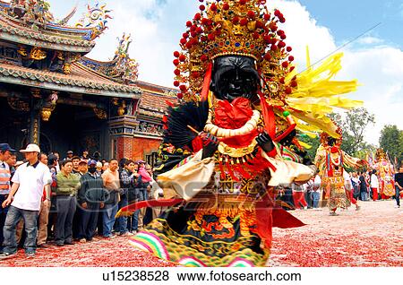 Stock Photo - Performer performing in front of temple. Fotosearch