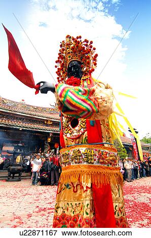 Stock Photo - Performer performing in front of temple. Fotosearch