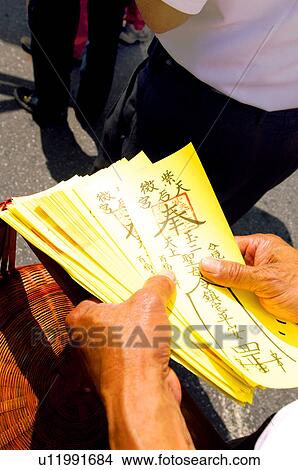 Picture - Man holding Taoist magic figures in a festival, Mazu Festival, China. Fotosearch