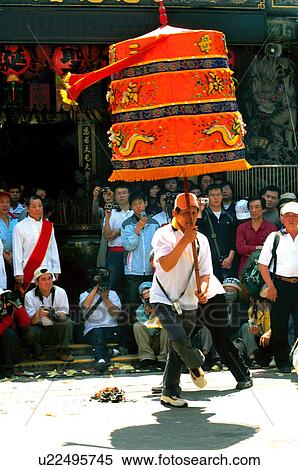 Stock Photography - Man performing during mazu festival, China. Fotosearch