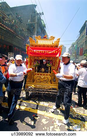 Stock Image - Men carrying a pagoda, China. Fotosearch